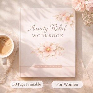 May include: A white workbook titled "Anxiety Relief Workbook" with floral illustrations. The cover features the text "Heal Your Mind" and "30 Page Printable". A cup of coffee sits to the left of the book.