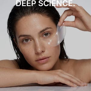 May include: A translucent, crescent-shaped under-eye patch held up near the face. The text DEEP HYDRATION. DEEP SCIENCE. appears at the top, and Advanced technology locks in moisture for visible results you can see and feel. is at the bottom.