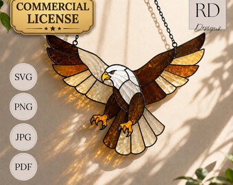 May include: A stained glass eagle suncatcher with outstretched wings, featuring brown, white, and amber glass segments with black lead lines. The design includes text labels for Commercial License, SVG, PNG, JPG, PDF, and RD Designs.