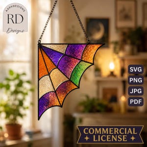 Puede incluir: Un atrapasoles triangular de vidrieras con un patrón de telaraña y paneles texturizados en tonos morado, naranja, amarillo y verde. La pieza está enmarcada en metal negro y cuelga de una fina cadena de metal negro.