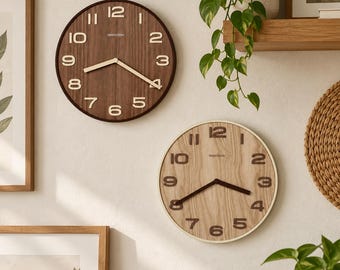 May include: Two circular wall clocks with wooden faces and raised numerals. The top clock features a dark brown wood grain with light-colored numbers and hands. The bottom clock has a light oak wood grain with dark brown numbers and hands.