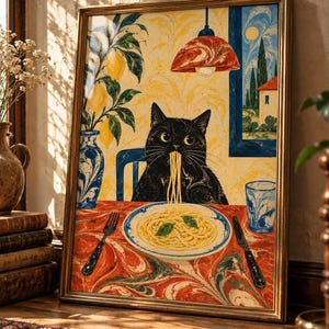 May include: A framed art print depicting a black cat sitting at a table eating a plate of spaghetti. The scene features a red marbled tablecloth, a blue vase with yellow lemons, a red pendant lamp, and a window view of a house and trees.
