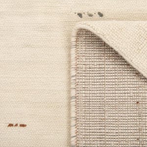 May include: Cream-colored woven rug with a geometric design. The rug features small black and brown accents, with a folded corner revealing the underside's grid pattern. The texture appears soft and inviting, suitable for home decor.