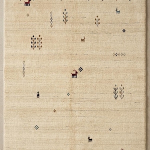 May include: A rectangular area rug in a light cream color featuring a fringe on the top and bottom edges. The rug is decorated with small, scattered, multi-colored geometric motifs, including stylized animals, trees, and diamond shapes.