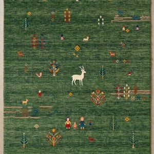 May include: A rectangular area rug in a deep forest green hue featuring a repeating pattern of small, colorful embroidered motifs including a central white deer, various stylized trees, birds, dogs, and small human figures scattered throughout.
