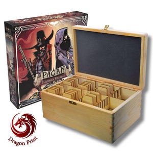 May include: Wooden game box with the Pagan game box art. The box is open, revealing wooden dividers and game pieces. The Pagan game box features illustrations of two figures in dark attire. The Dragon Print logo is visible.