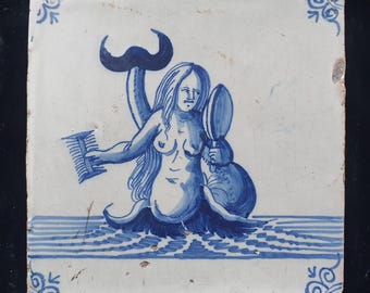 Delft tile shows a mermaid admiring herself in a mirror and with a comb in her hand; Antique 17th century (1640), collector's tile.
