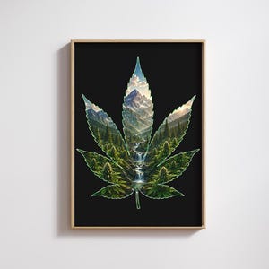 Op de afbeelding: Een ingelijste rechthoekige wandkunstprint met het silhouet van een groot cannabisblad tegen een zwarte achtergrond. De binnenkant van het blad toont een gedetailleerd landschap van besneeuwde bergen, een dennenbos en een waterval.