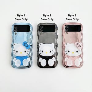 May include: Three phone cases featuring a Hello Kitty design. The cases are in blue, gray, and pink, each with a different outfit and bow. The text "Style 1 Case Only", "Style 2 Case Only", and "Style 3 Case Only" are printed above each case.