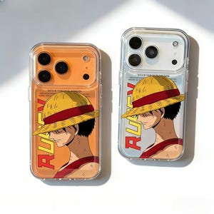 May include: Two clear phone cases featuring a cartoon illustration of a character wearing a straw hat and a red shirt. The word "RUFFY" is printed vertically on the side of the case. The background of one case is orange, and the other is light blue.