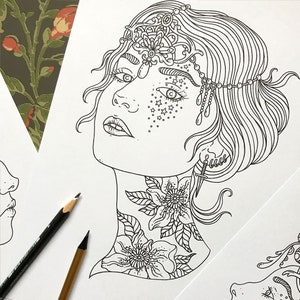 May include: A black and white line drawing of a woman's face with a crown and floral designs on her neck. The woman has a delicate, intricate crown with a flower design on top. Her face is adorned with stars and a small dagger is behind her ear. The floral designs on her neck are detailed and intricate.