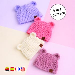 May include: Four handmade crochet bear hats in pastel colors: lavender, pink, cream, and mauve. Each hat has small, rounded ears and a brown label. The image includes the text "4 in 1 pattern".