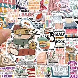 May include: A sticker sheet featuring various book-themed designs. The central sticker shows a stack of books in shades of brown, green, and pink, adorned with floral accents. Surrounding stickers include phrases like "Read," "Books," and "Reading Never Judge a Book."