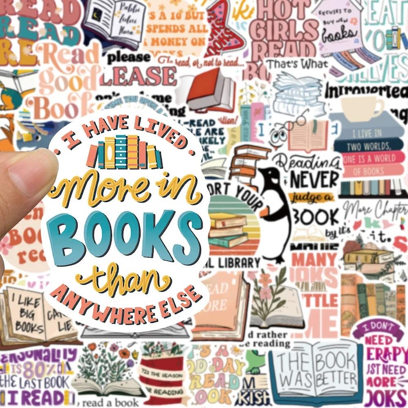 May include: A collection of colorful stickers with book-themed quotes and illustrations. The central sticker reads "I have lived more in BOOKS than anywhere else." Other stickers feature books, penguins, and phrases like "Reading Never Judge a Book".