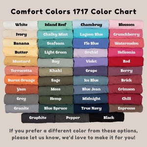 May include: A color chart titled "Comfort Colors 1717 Color Chart" displays a variety of fabric colors. The chart includes shades like white, ivory, banana, butter, mustard, terracotta, burnt orange, yam, grey, and granite. Additional colors are also shown.