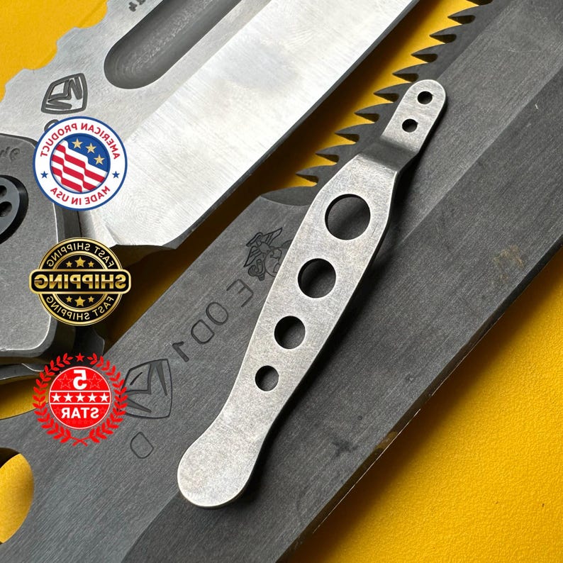 May include: Close-up of a collection of tactical knives. The blades are dark gray with a serrated edge on one. A silver-colored tool with three holes and a handle is also visible. The background is yellow.