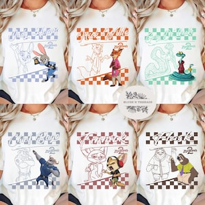 May include: White t-shirts featuring characters from the movie Zootopia, including Judy Hopps, Nick Wilde, and Chief Bogo. Each shirt has a character illustration and name, with a checkered pattern at the bottom. The text "Zootopia 2" is also present.