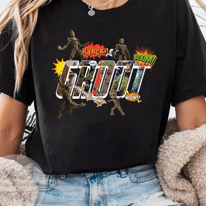 May include: Black t-shirt featuring a comic book style design with the word "GROOT" in large, white outlined letters. The design includes images of Groot and speech bubbles with phrases like "RAACK!" and "BOOM!"