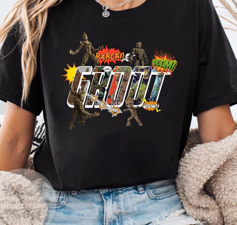 May include: Black t-shirt featuring a comic book style design with the word "GROOT" in large, white outlined letters. The design includes images of Groot and speech bubbles with phrases like "RAACK!" and "BOOM!"