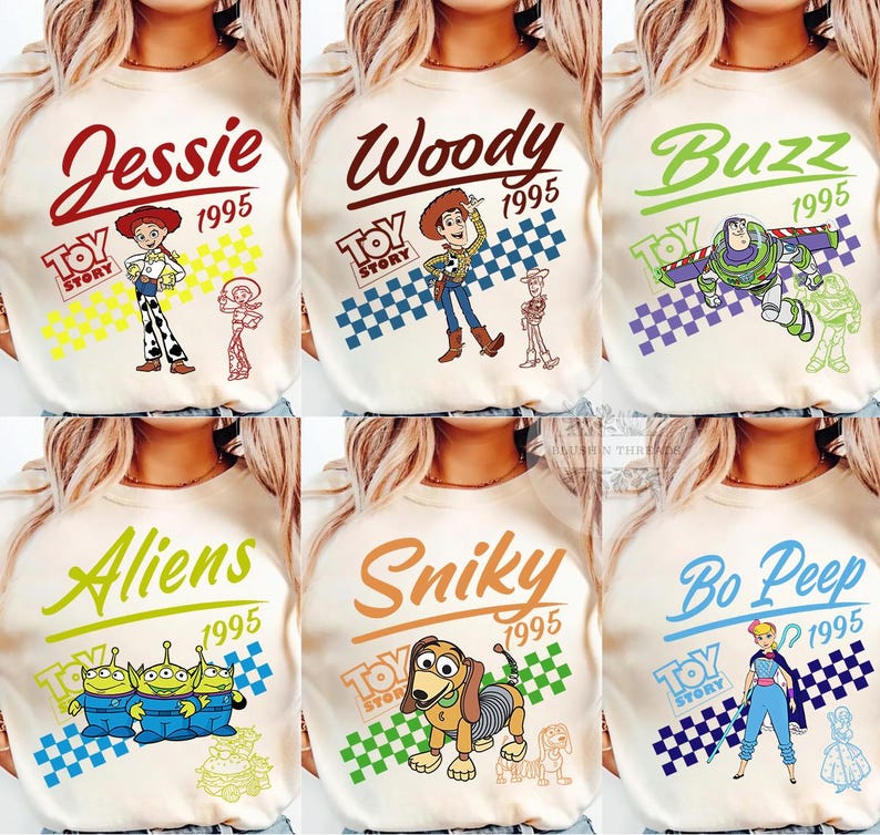 May include: Cream-colored long-sleeve shirts featuring various Toy Story characters: Jessie, Woody, Buzz, Aliens, Slinky, and Bo Peep. Each shirt has the character's name, the year 1995, and the Toy Story logo. The designs include colorful illustrations.