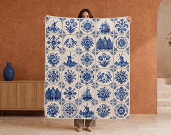 May include: A large rectangular textile featuring a grid of blue and white tiles. The pattern includes illustrations of Dutch windmills, tulips, sailing ships, canal houses, floral motifs, and birds, all rendered in a classic delft blue style.