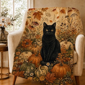 May include: A throw blanket featuring a black cat sitting among orange and green pumpkins, autumn leaves, and wildflowers. The design displays a warm, seasonal color palette with detailed botanical illustrations and a central feline figure.