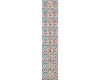 May include: A long, rectangular table runner featuring a dense, repeating floral pattern. The design consists of small, intricate blossoms in shades of pink, yellow, orange, and purple, set against a light blue background with green foliage.