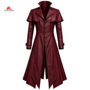 May include: A dark red long coat featuring a high collar, a button-front closure, and a cape-style overlay on the shoulders. The coat has long sleeves with buckled straps at the cuffs and an asymmetrical hemline that falls below the knees.