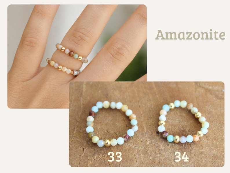 May include: Two elastic rings made of small, round, multi-colored amazonite beads interspersed with shiny gold-toned metallic spheres. The rings are labeled 33 and 34, featuring a mix of light blue, tan, brown, and cream-colored stone beads.