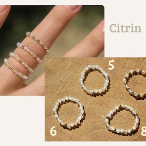 May include: Four delicate beaded rings featuring small, translucent, pale yellow citrine stones interspersed with tiny metallic gold-tone beads. The rings are shown both worn on fingers and arranged individually, labeled with the numbers 5, 6, 7, and 8.