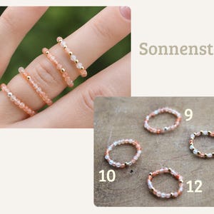 May include: A collection of beaded rings featuring small peach-colored stones and metallic accents. The rings are displayed on fingers and individually labeled with the numbers 9, 10, 11, and 12. The text Sonnenstein is visible in the upper right corner.