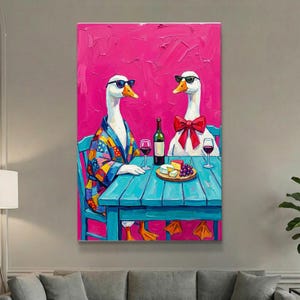 May include: An oil painting depicts two geese wearing sunglasses, seated at a blue table with wine, cheese, and grapes. One goose wears a colorful robe, the other a red bow tie. The background is a vibrant pink.