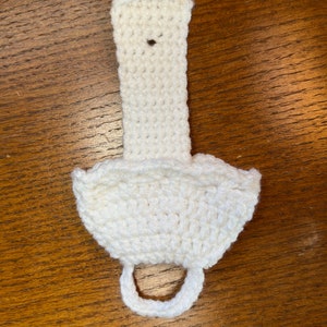 Back of crochet towel holder on a table