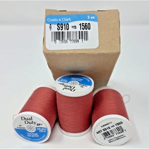 May include: Three spools of terracotta-colored Coats & Clark Dual Duty XP all-purpose polyester thread, each containing 250 yards. The spools are presented with their original brown cardboard box, which displays the product code S910 H5 1560.