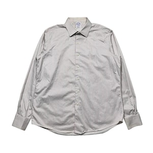 May include: A long-sleeved button-down shirt with vertical stripes in shades of gray and white. The shirt has a classic collar and buttoned cuffs. The Brooks Brothers logo is visible on the chest.