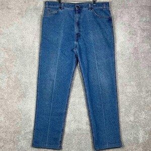 May include: A pair of medium-wash blue denim jeans featuring a classic five-pocket design, a high-rise waist with belt loops, a metal button closure, and a zippered fly. The straight-leg trousers have visible stitching along the seams and pockets.