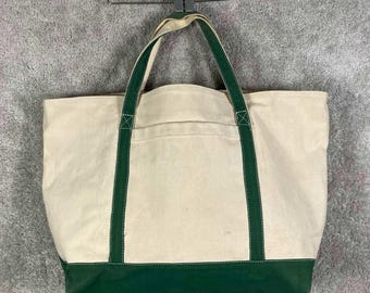 Bolso de lona grande estilo vintage con ribete verde y cierre de cremallera.