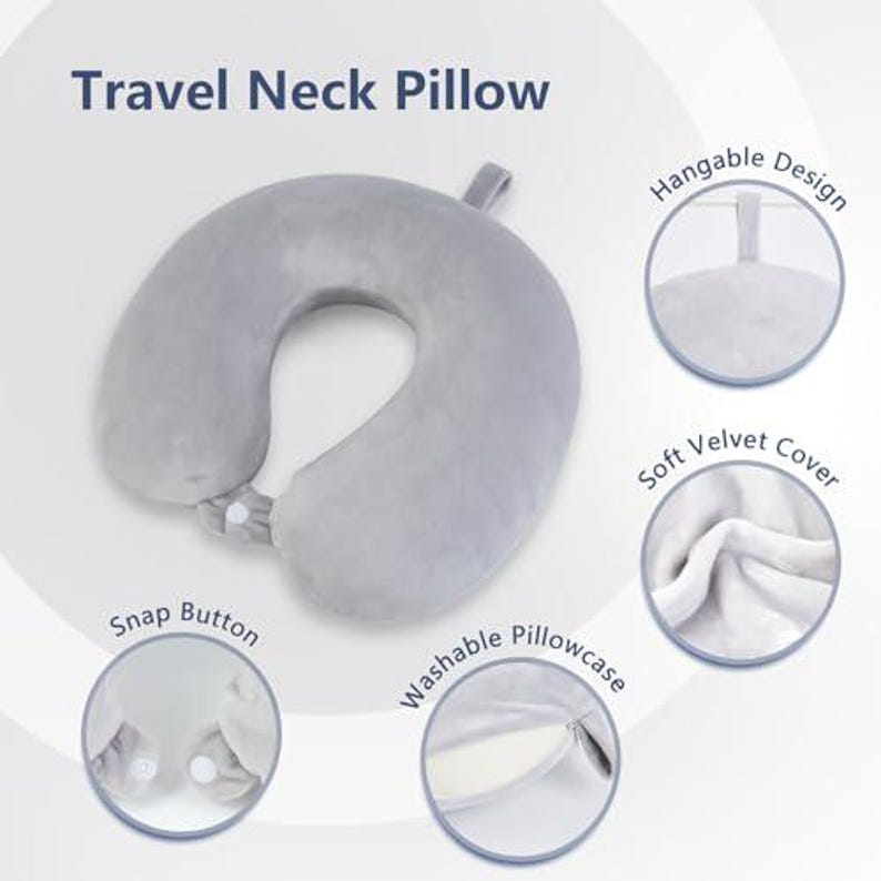 May include: A gray travel neck pillow with a snap button closure and a hangable design. The pillow has a soft velvet cover and a washable pillowcase. The text "Travel Neck Pillow" is at the top of the image.