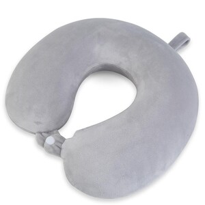 May include: A gray travel neck pillow with a U-shape design. The pillow has a soft, plush texture and a snap closure. A small loop is attached to the side. This travel pillow is designed for comfort and support during travel.