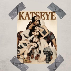 May include: A poster with the word "KATSEYE" in brown lettering is taped to a light grey surface. The poster features a group of women in various outfits, including denim shorts, plaid shirts, and sweaters. The women are posed together.