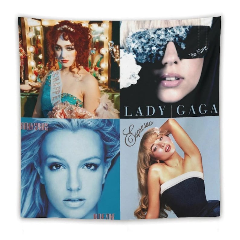 May include: A wall tapestry featuring four celebrity portraits. The top left shows a woman in a blue dress with a sash. The top right features Lady Gaga with the text "The Fame". The bottom left is Britney Spears with "In The Zone". The bottom right is a woman with the text "Espressa".
