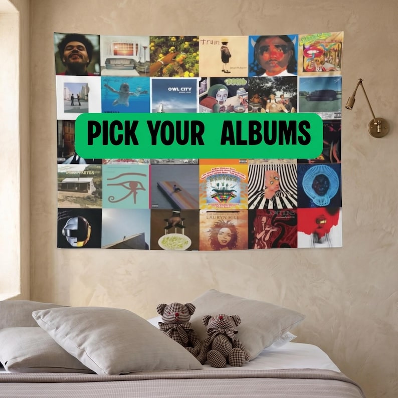 May include: A tapestry featuring a collage of album covers, with a green banner that reads "PICK YOUR ALBUMS". The tapestry is hanging on a beige wall above a bed with pillows and teddy bears.
