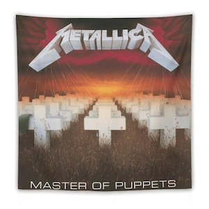 May include: A Metallica "Master of Puppets" tapestry. The design features the band's logo in white, above a field of white crosses, with a sunset backdrop. The words "MASTER OF PUPPETS" are printed at the bottom.