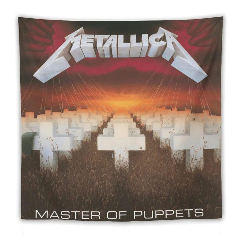 May include: A Metallica "Master of Puppets" tapestry. The design features the band's logo in white, above a field of white crosses, with a sunset backdrop. The words "MASTER OF PUPPETS" are printed at the bottom.