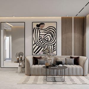 May include: A modern living room featuring a beige sofa with decorative pillows, a round coffee table, and a large abstract artwork in black and white. A full-length mirror and a patterned rug complete the stylish interior design.