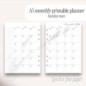 May include: A5 monthly printable planner with a Sunday start. The calendar pages are white with a grid layout, featuring the month of December 2026. The text "Jardin fine paper" is at the bottom.