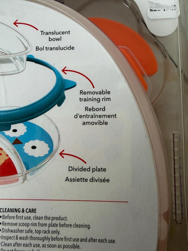 May include: A baby feeding set with a translucent bowl, a removable training rim, and a divided plate. The plate features a blue and white owl design. The packaging includes cleaning and care instructions.
