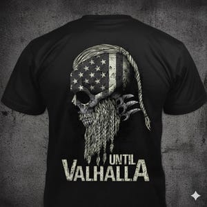 May include: Black t-shirt featuring a skull design with an American flag motif on the head. The skull has a braided beard and the text "UNTIL VALHALLA" in a distressed font.