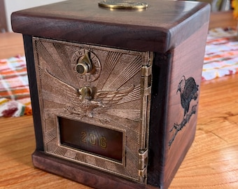 May include: A wooden box with a dark brown finish featuring a brass post office door on the front. The door displays an embossed eagle, a circular dial, and the number 206 in a window. A small eagle is engraved on the side of the wooden frame.