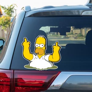 May include: A car window sticker featuring a yellow cartoon character. The character, wearing a white shirt, is giving the middle finger with both hands. The sticker is on the rear window of a grey car.
